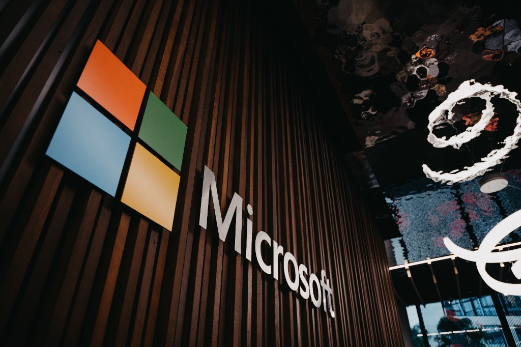 Microsoft logo and wordmark in a corporate lobby