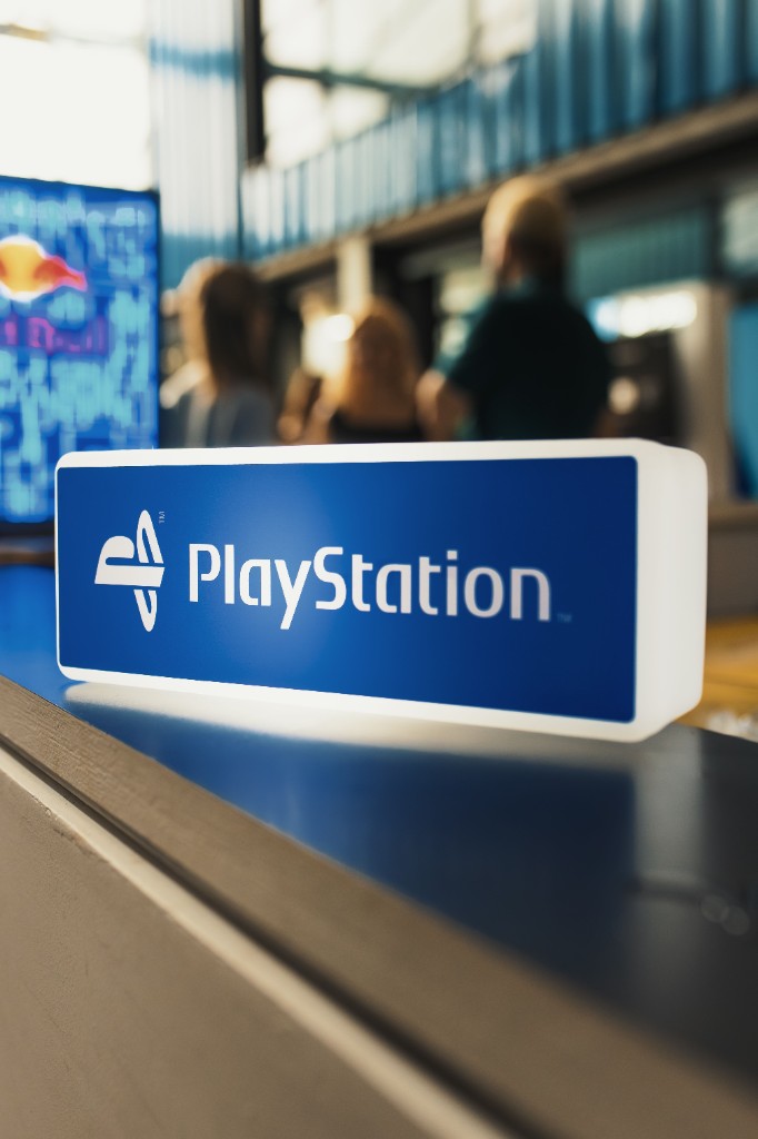Illuminated PlayStation brand sign at an industry event